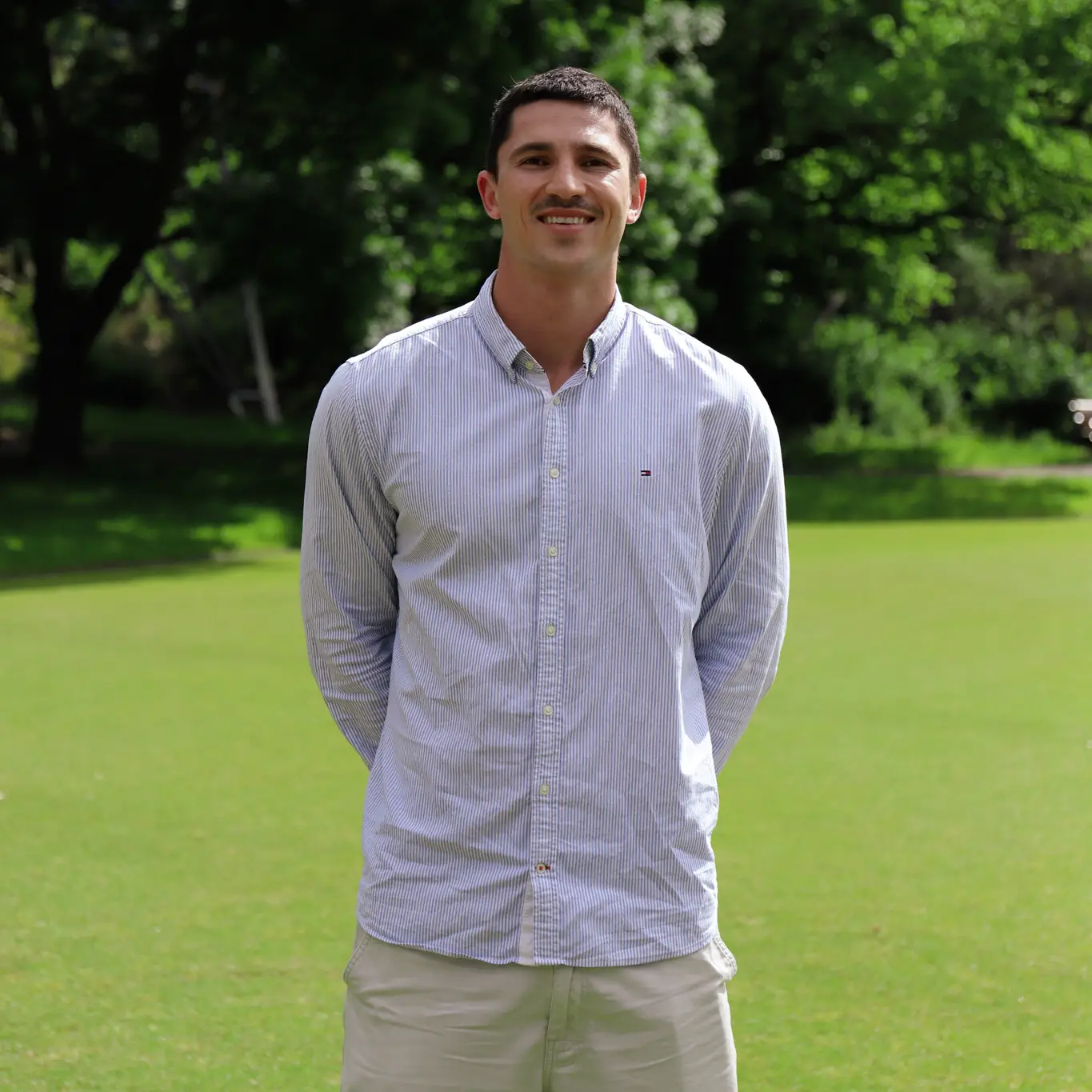 Ed Delany hands behind back smiling